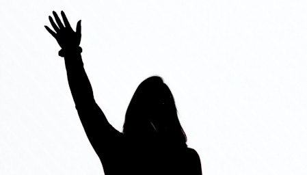 Silhouette ombre. Une personne levant la main.